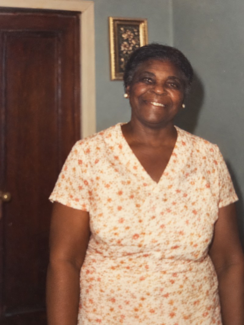 Evelyn Julia Minns Rolle, smiling, in a floral dress