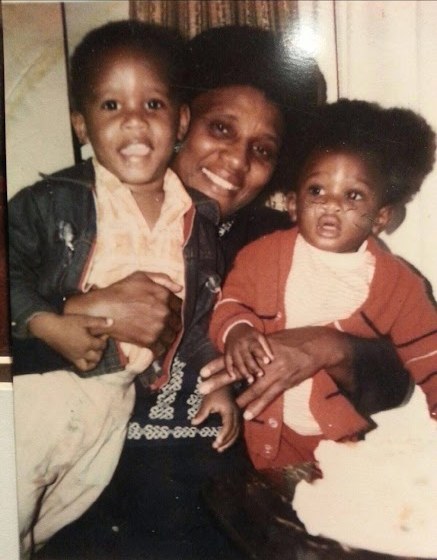 Mother Virginia Smith smiling, holding two young grandsons on her lap